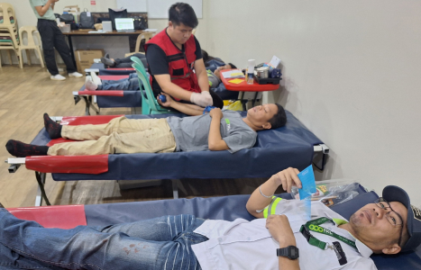 Two Men Lying on Bed Participating in Blood Donation